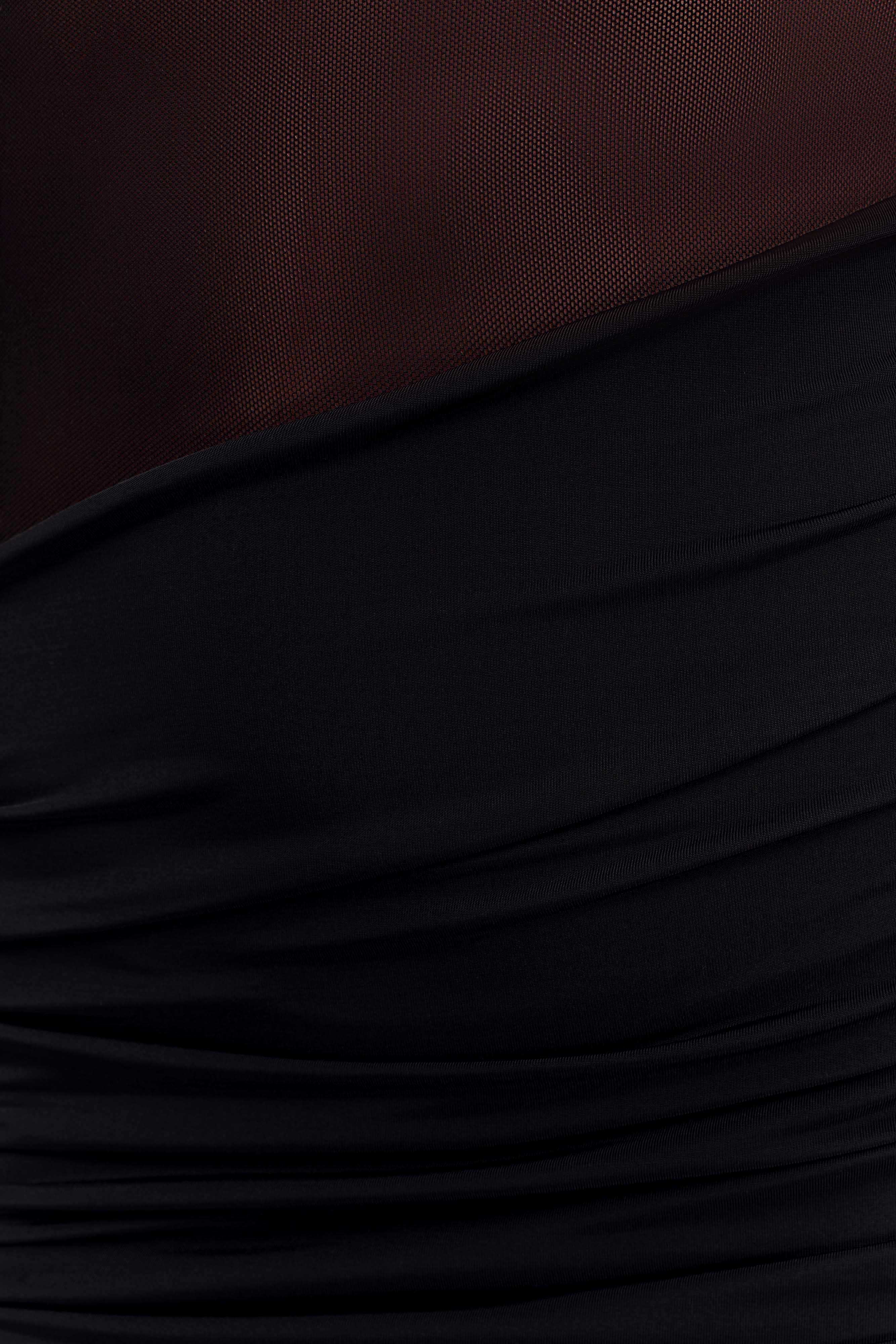 Close-up detail of the black Luella maxi dress showing the textured ruching and sheer mesh cutout fabric.