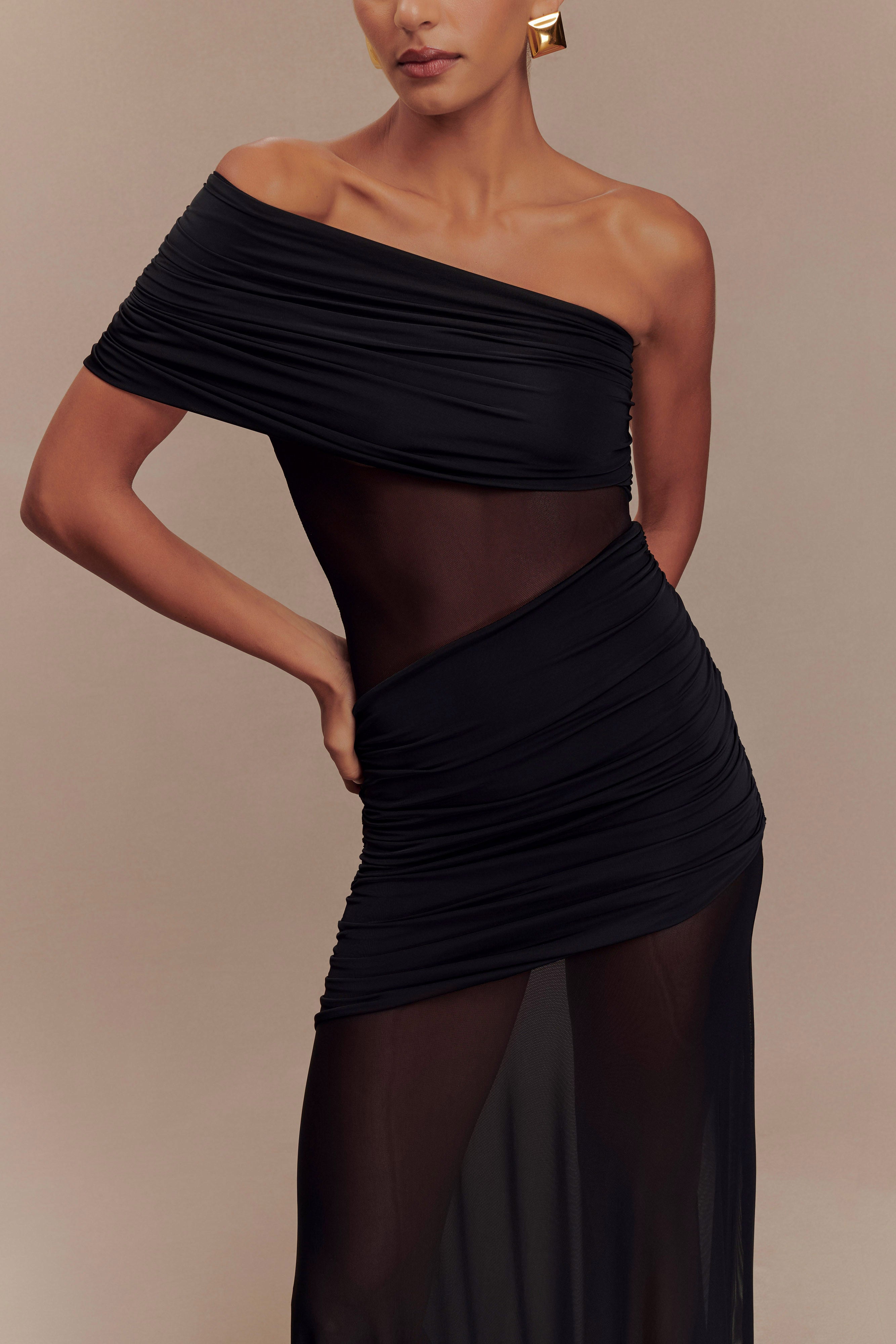 Mid-section view of the black Luella cutout maxi dress, focusing on the sheer waist and ruched skirt details.
