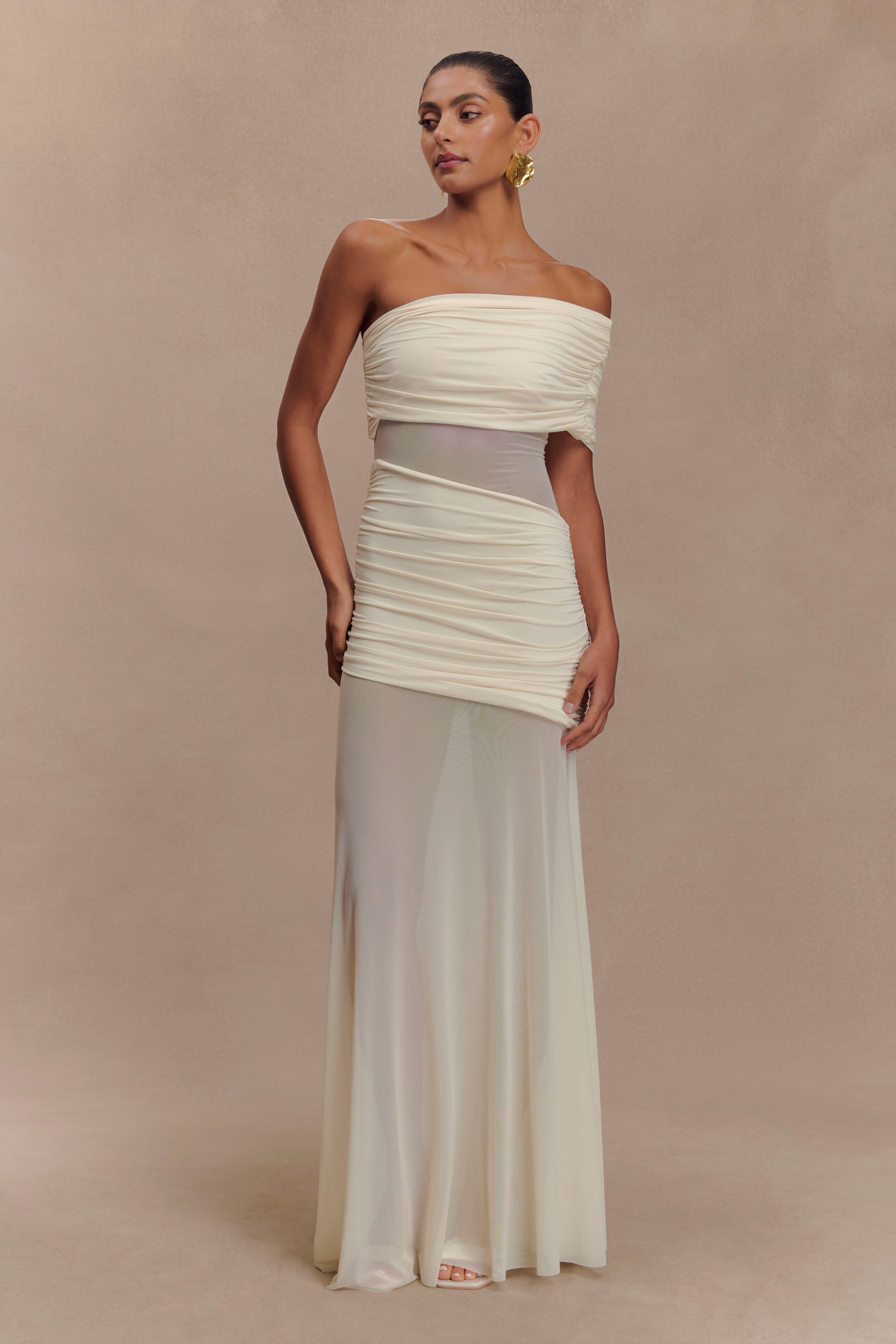 Front view of the ivory Luella cutout maxi dress, highlighting the ruched bodice and sheer skirt panel.