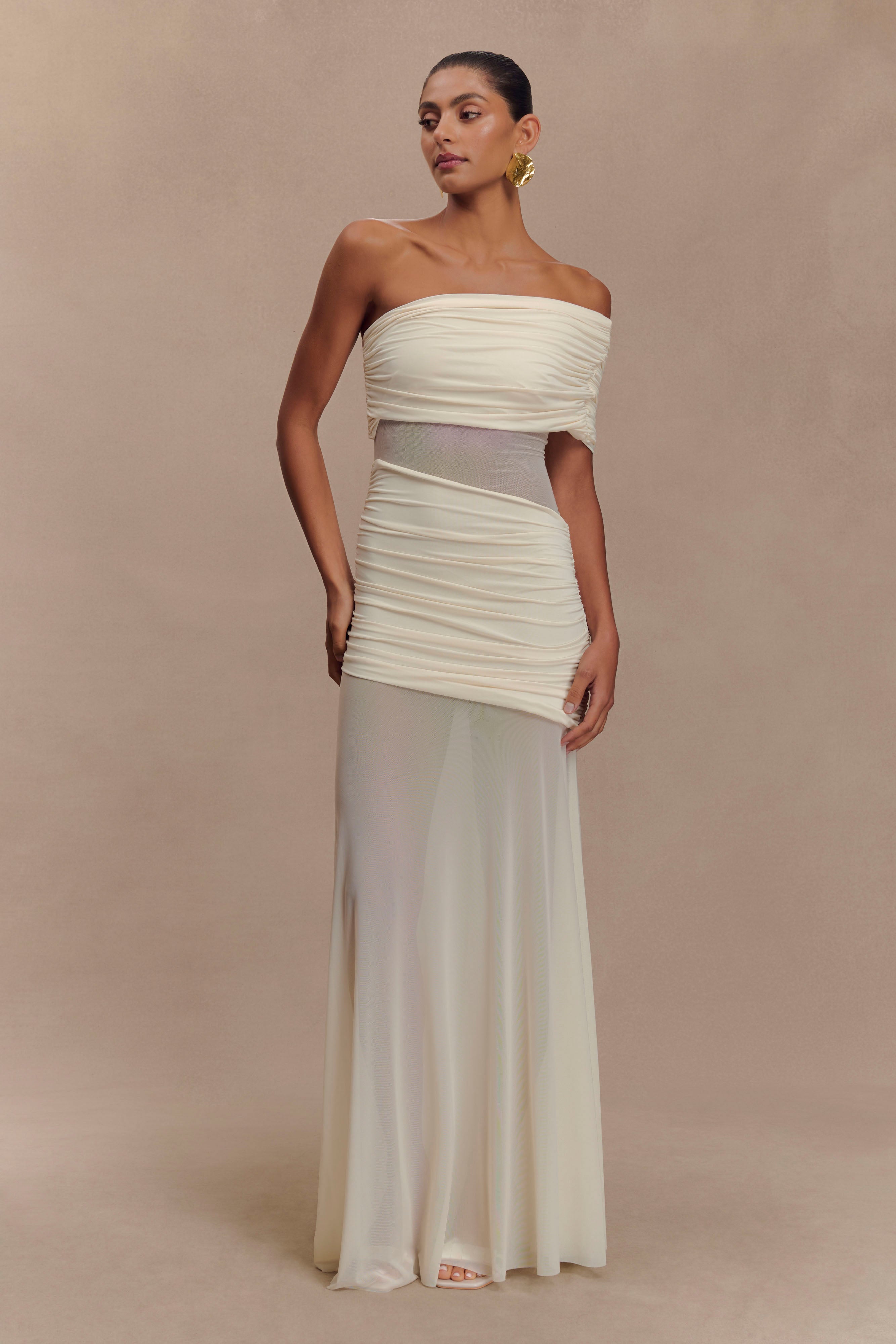 Front view of the ivory Luella cutout maxi dress, highlighting the ruched bodice and sheer skirt panel.