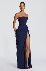 Full-length navy strapless maxi dress with ruched bodice and wrap-style slit, wide shot