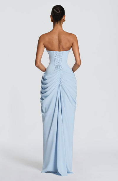 Back view of light blue ruched maxi dress featuring lace-up corset detail and ruching