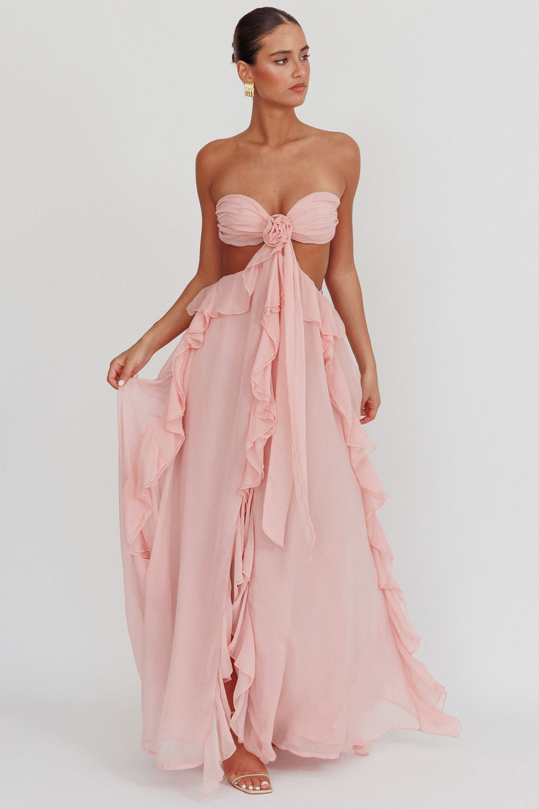 Light pink Madeleine Rosette Maxi Dress with strapless bodice and front rosette detail, flowing ruffles on the skirt.