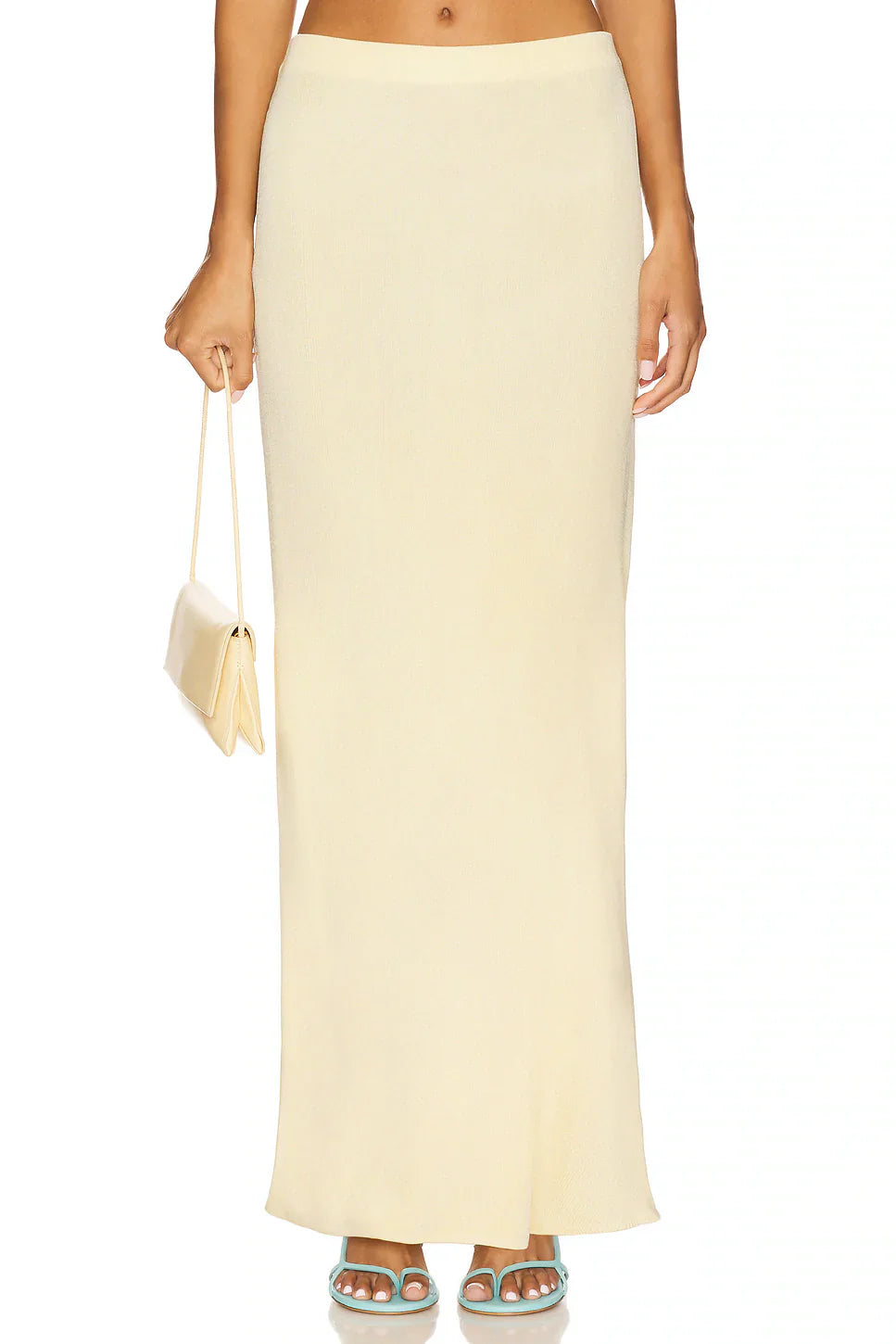 Close-up front view of the lower half of a light yellow maxi dress showing the flowing fabric for women