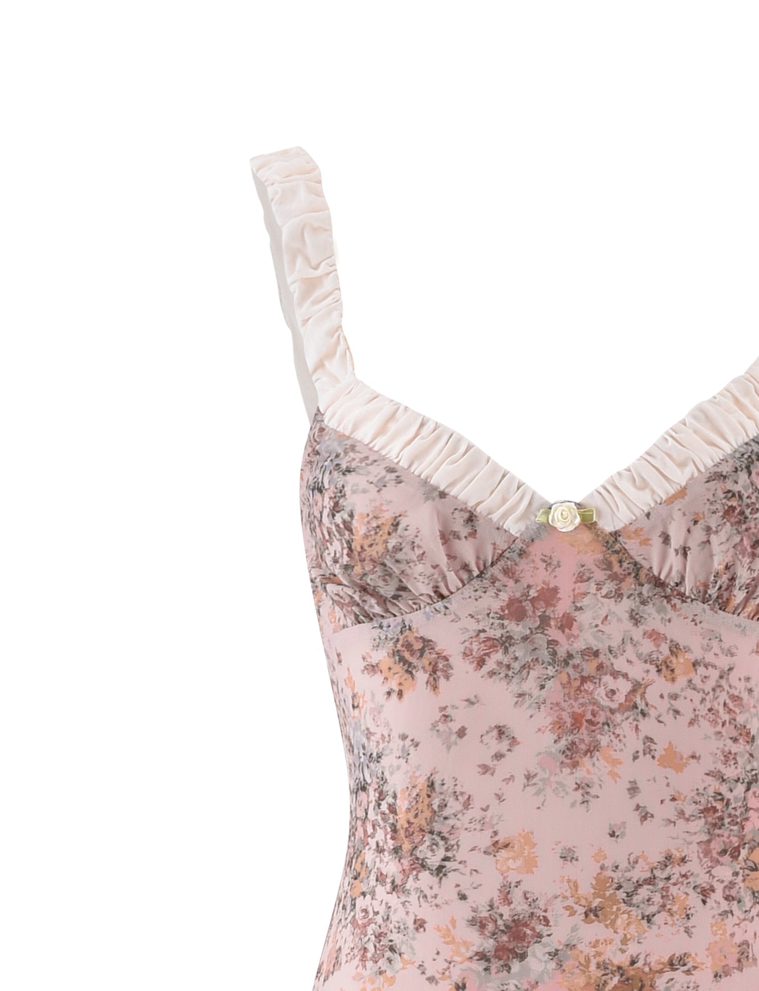 Detailed close-up of the pink floral print fabric, white ruffled straps, and delicate bow on the maxi dress.