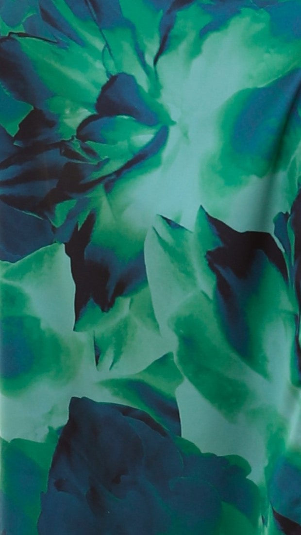 Close-up detail of the vibrant green and blue abstract floral print fabric on the Marina Floral Cutout Maxi Dress.