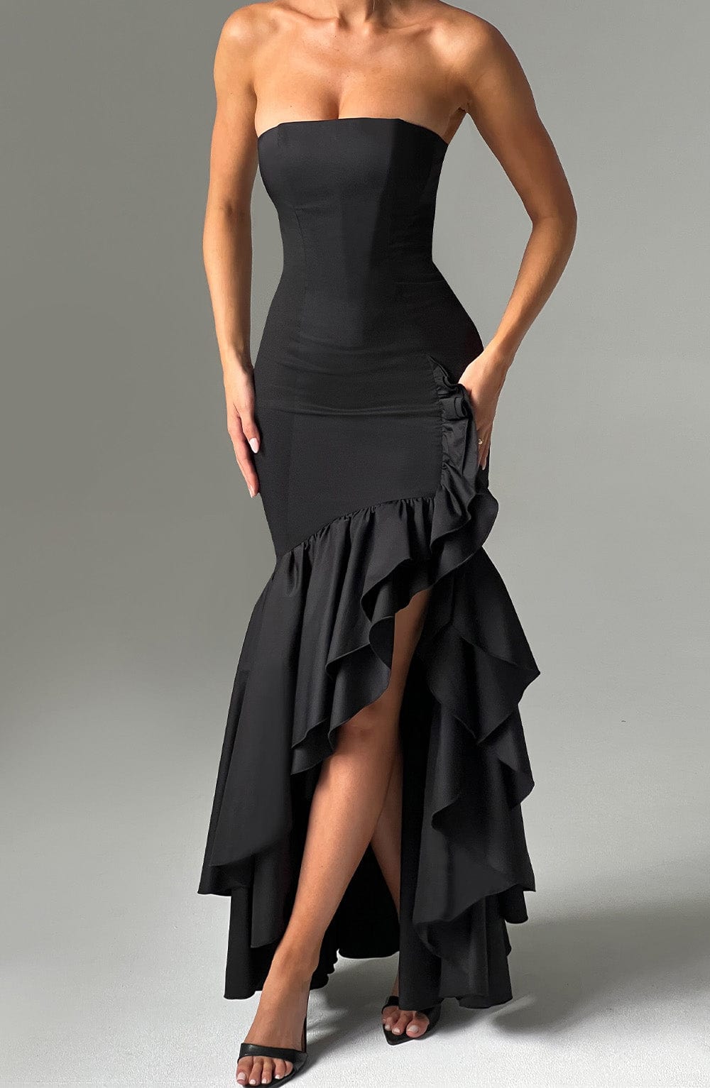 Close-up of the Marlowe Ruffle Maxi Dress in all black, focusing on the strapless bodice, ruched detailing, and the tiered high-low ruffle skirt.