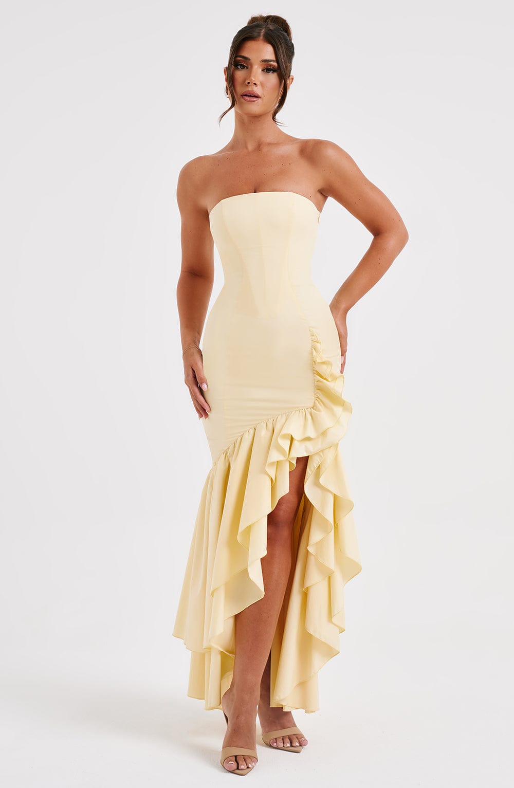 Marlowe Ruffle Maxi Dress in a soft yellow hue, highlighting the elegant strapless neckline and the playful, layered high-low ruffle skirt.