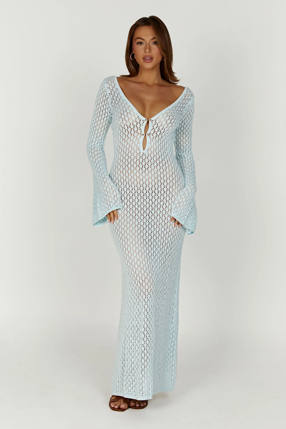Full-length view of a light blue crochet maxi dress with long bell sleeves and a deep V-neckline with tie detail.