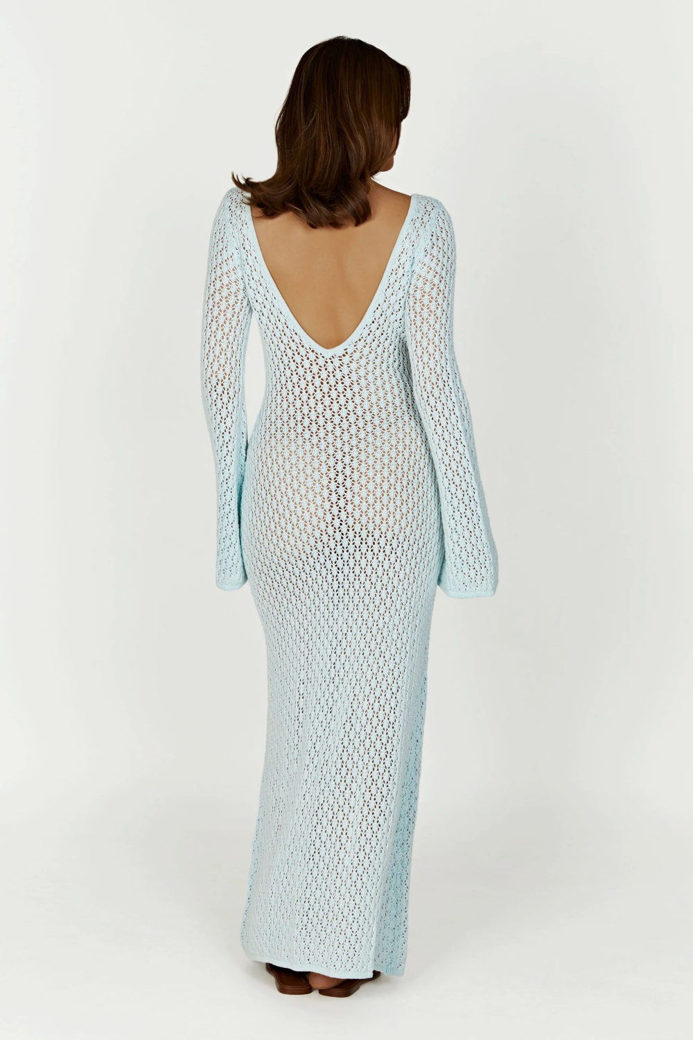 Back view of a light blue crochet maxi dress, showcasing the deep V-back and long bell sleeves.