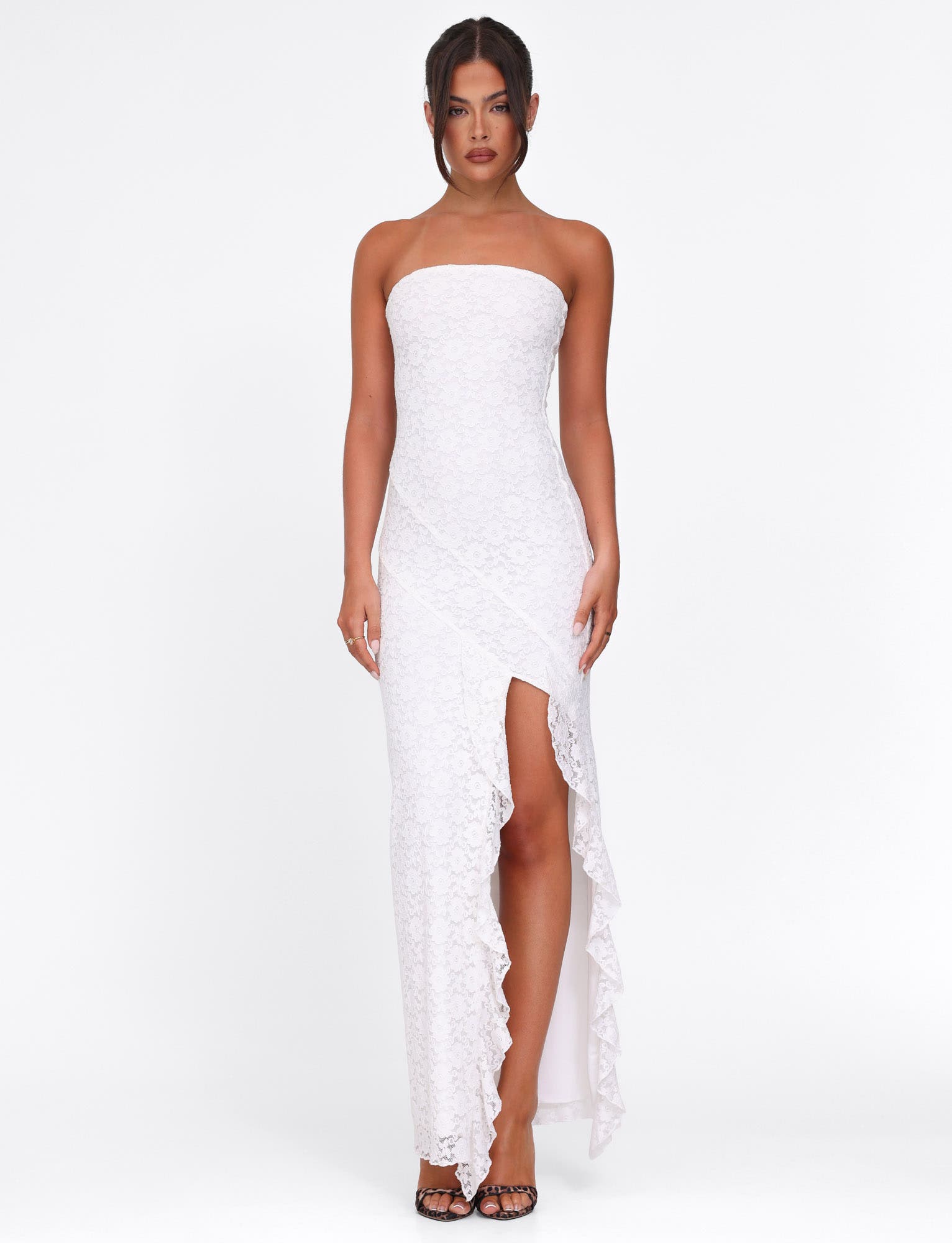 Elegant white lace strapless Megan Ruffle Maxi Dress with a ruffled high slit, showcasing texture.