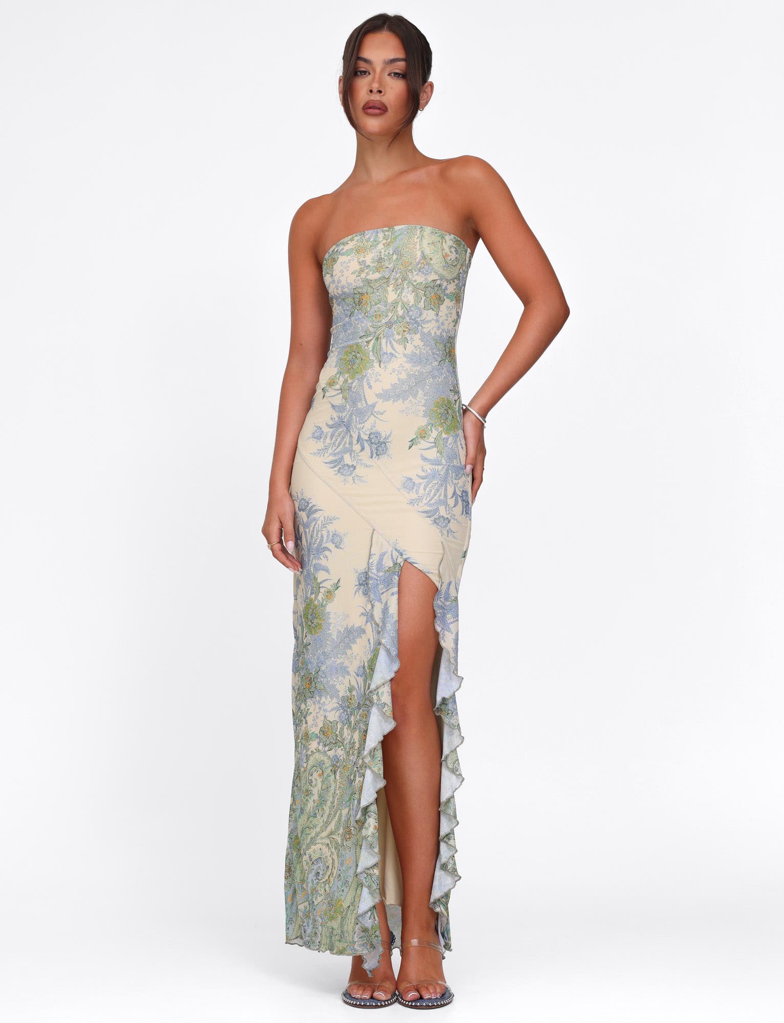 Front view of cream Megan Ruffle Maxi Dress with blue and green floral print, high ruffled slit.