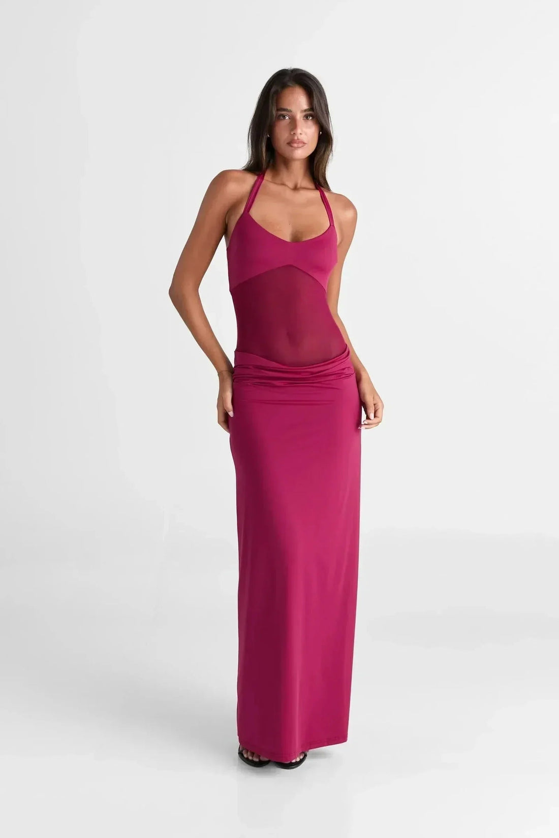 Front view of a women's Melanie Mesh Maxi Dress in a vibrant fuchsia, featuring a halter neckline and sheer mesh bodice.