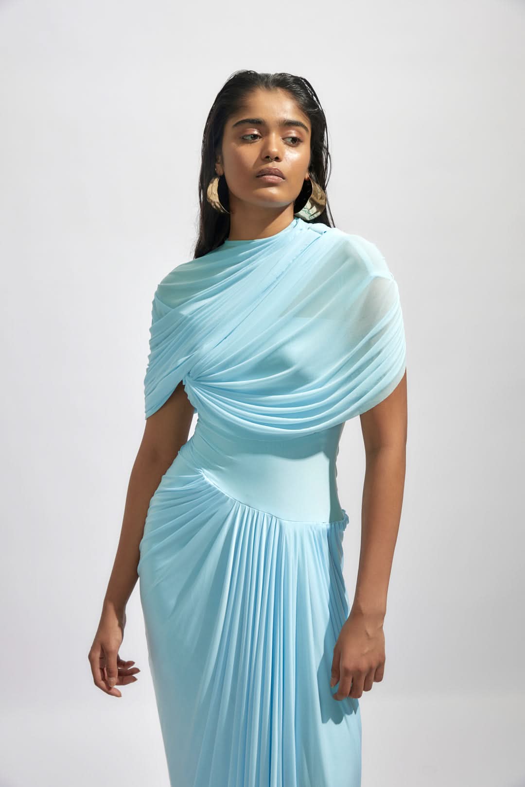 Close-up front view of the light blue Mira Draped Maxi Dress, highlighting the elegant shoulder and waist pleating.