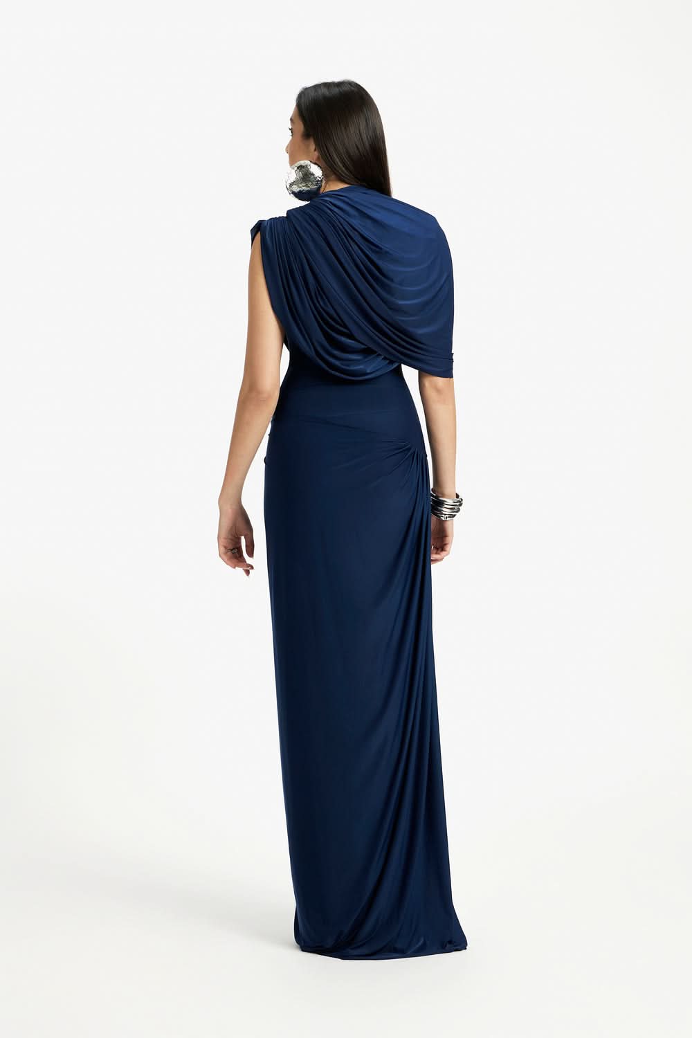 Rear view of the navy blue Mira Draped Maxi Dress, showing the flowing skirt and draped back design.