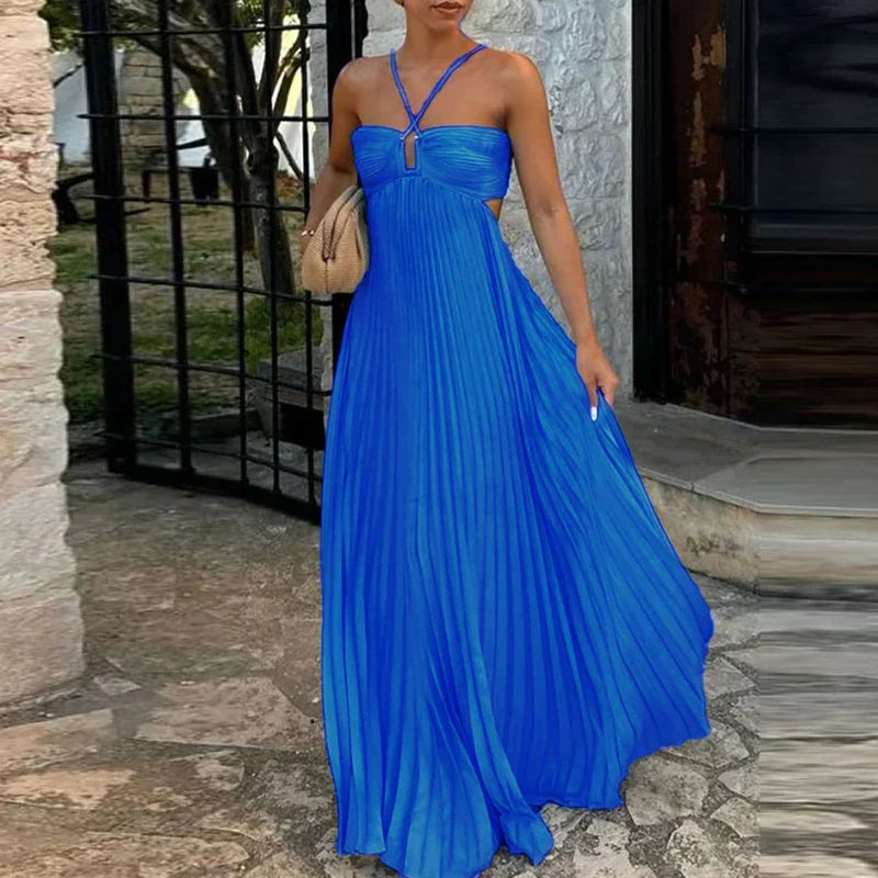 Royal blue pleated maxi dress with side cutouts and halter straps, a flowing women's dress.
