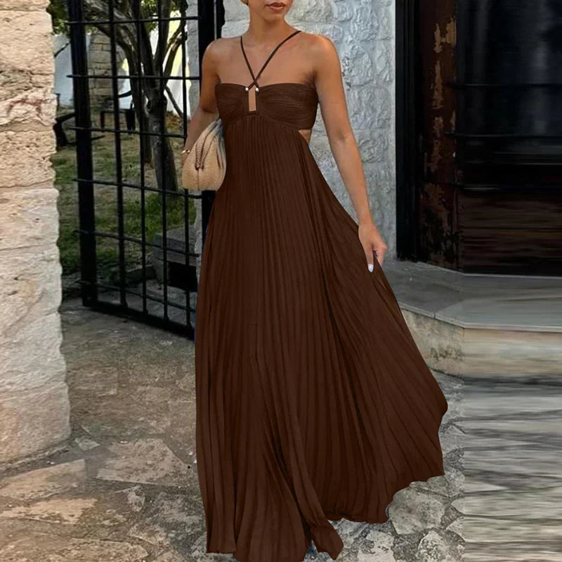 Dark brown pleated maxi dress with side cutouts and halter straps, a flowing women's dress.