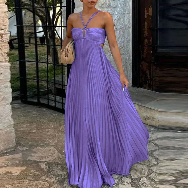 Lavender purple pleated maxi dress with side cutouts and halter straps, a flowing women's dress.