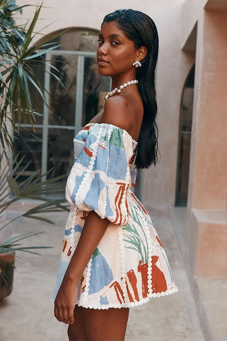 Side profile of a woman in a colorful patchwork mini dress with off-shoulder neckline and puff sleeves.