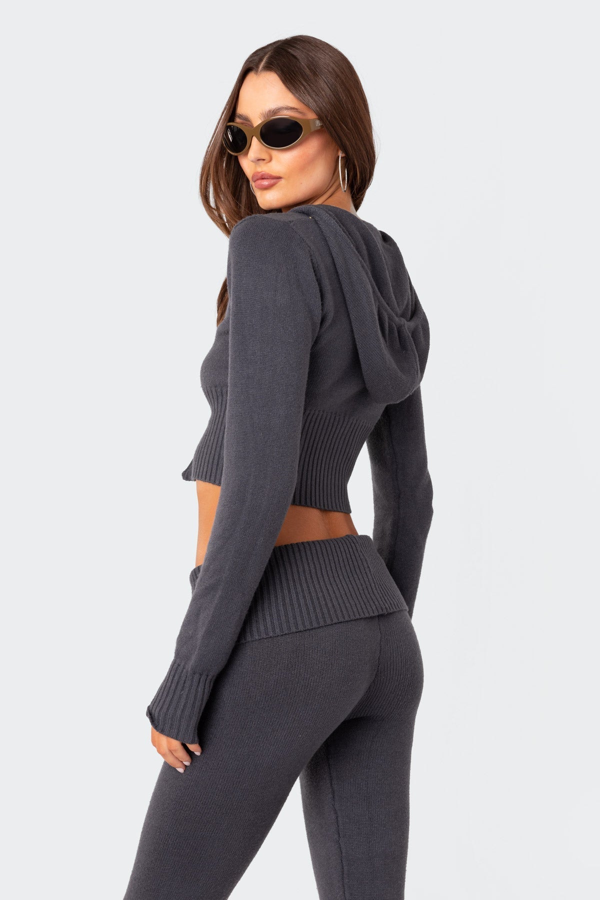 Back view of the charcoal grey casual lounge set, emphasizing the hood detail and the ribbed texture of the cropped top and slacks.
