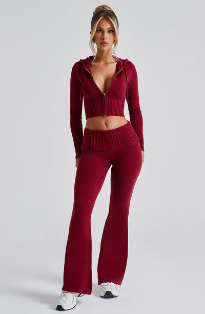 Women's deep red casual lounge set featuring a cropped zip-up hoodie and coordinating flared slacks with a ribbed waistband.