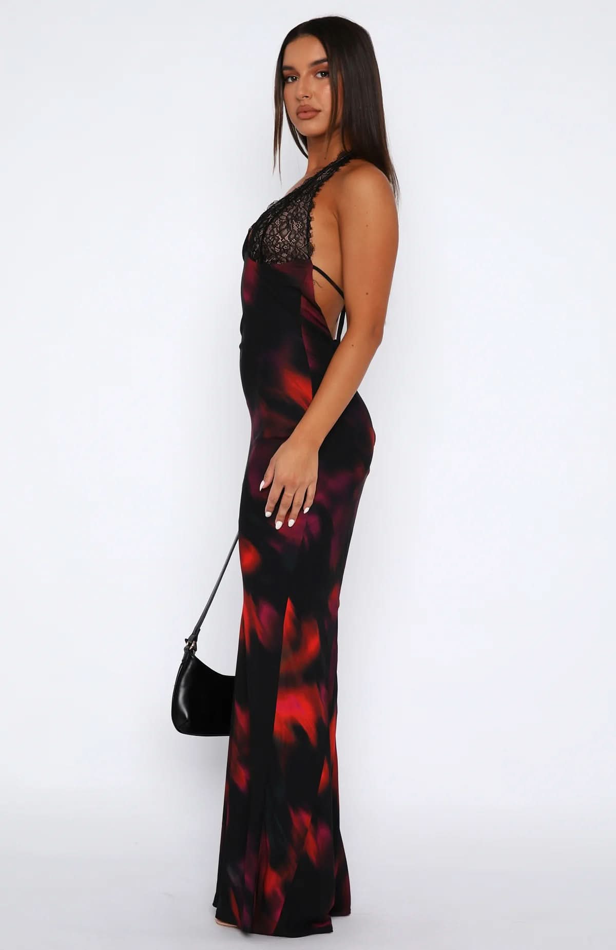 Side profile of multi-color maxi dress with black lace halter top on model for women