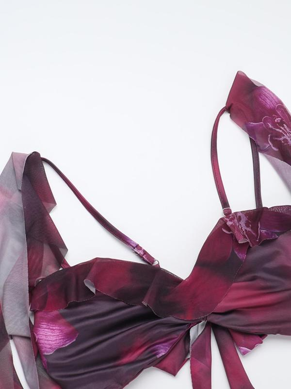 Close-up detail of the purple floral print fabric on the tie-front crop top with adjustable spaghetti straps and ruffled edges.