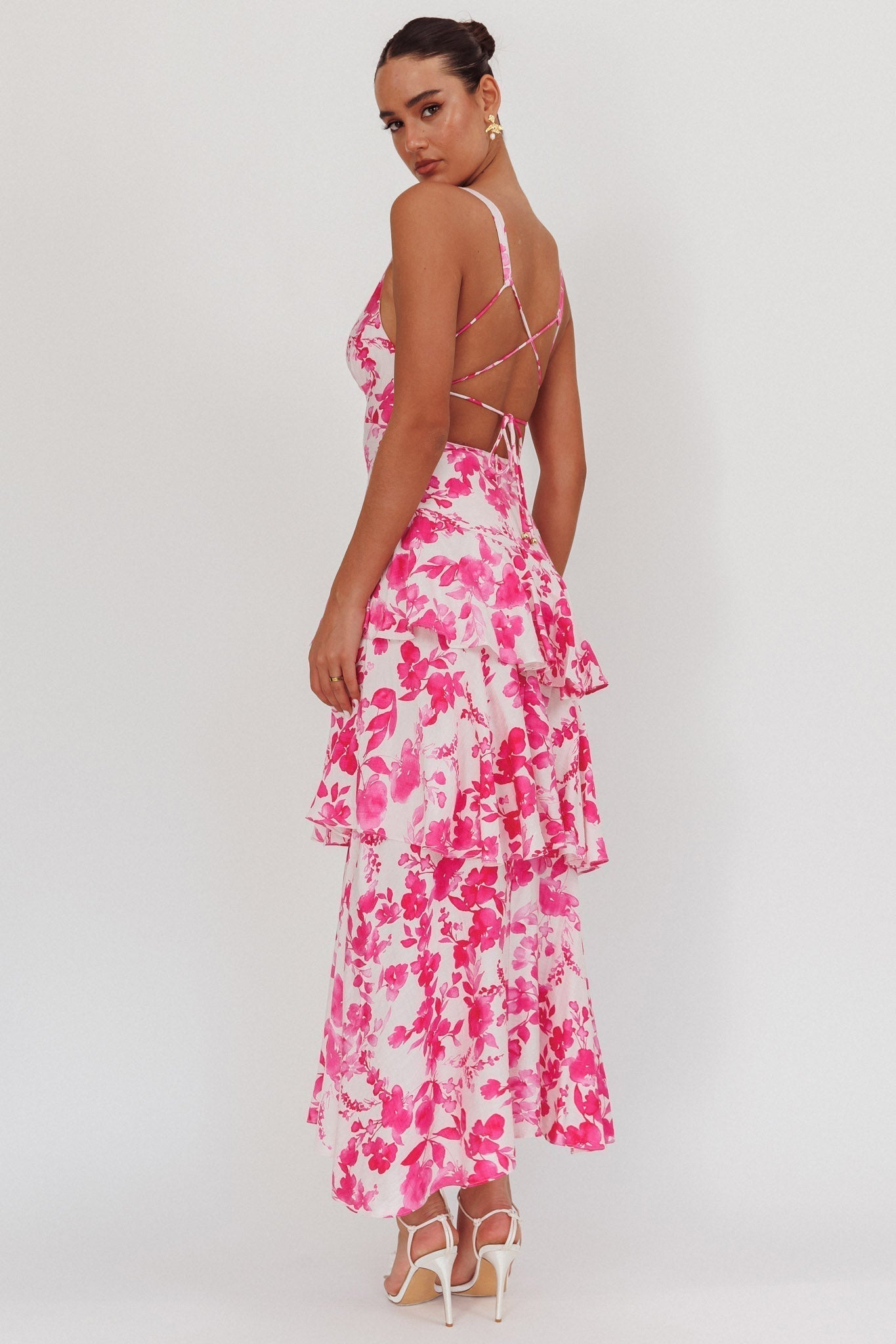 Back view of the white and fuchsia floral Harriet Ruffle Maxi Dress, featuring criss-cross back straps and tiered skirt.