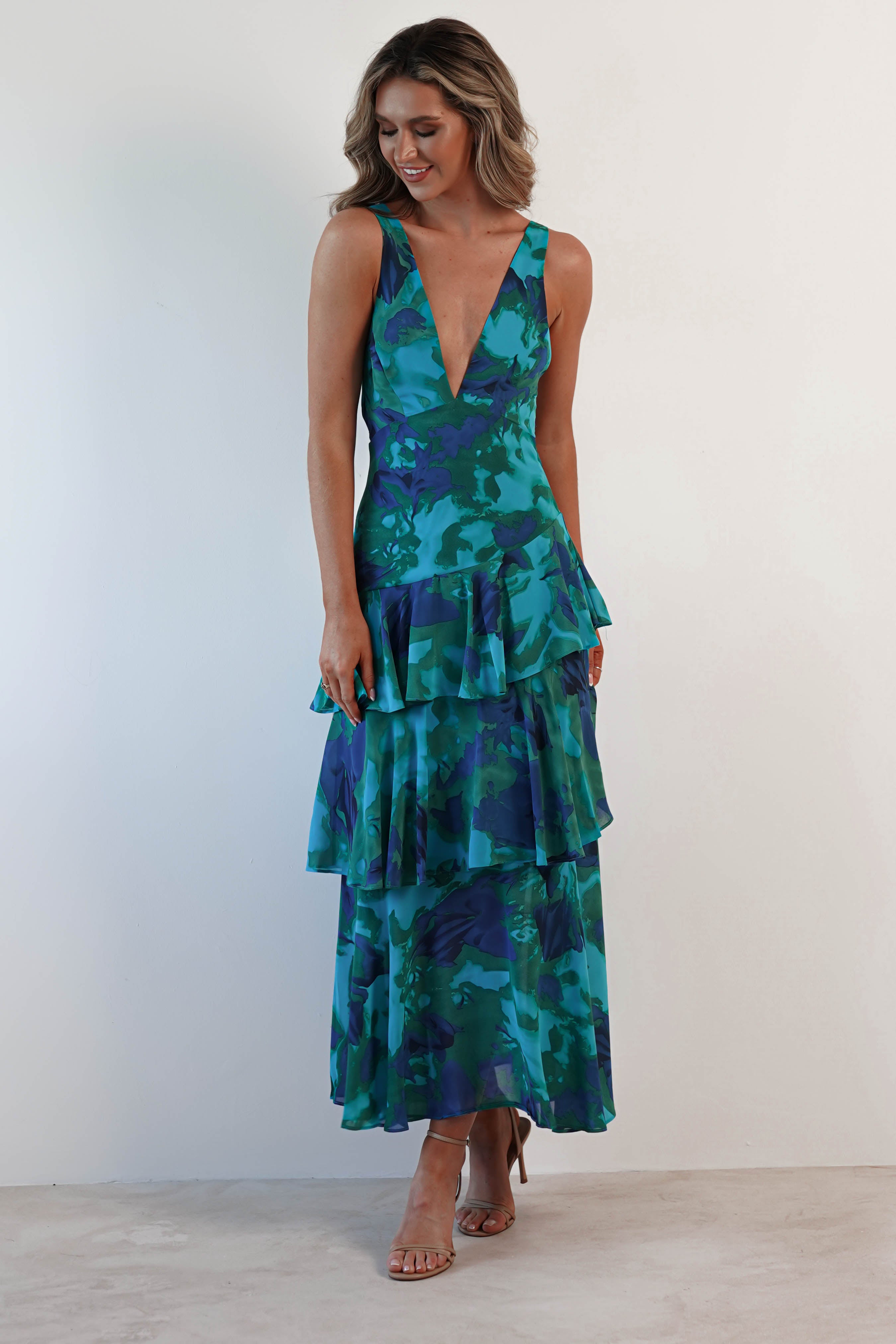Harriet Ruffle Maxi Dress in striking teal and blue floral print, showcasing a deep V-neck and ruffled tiers.