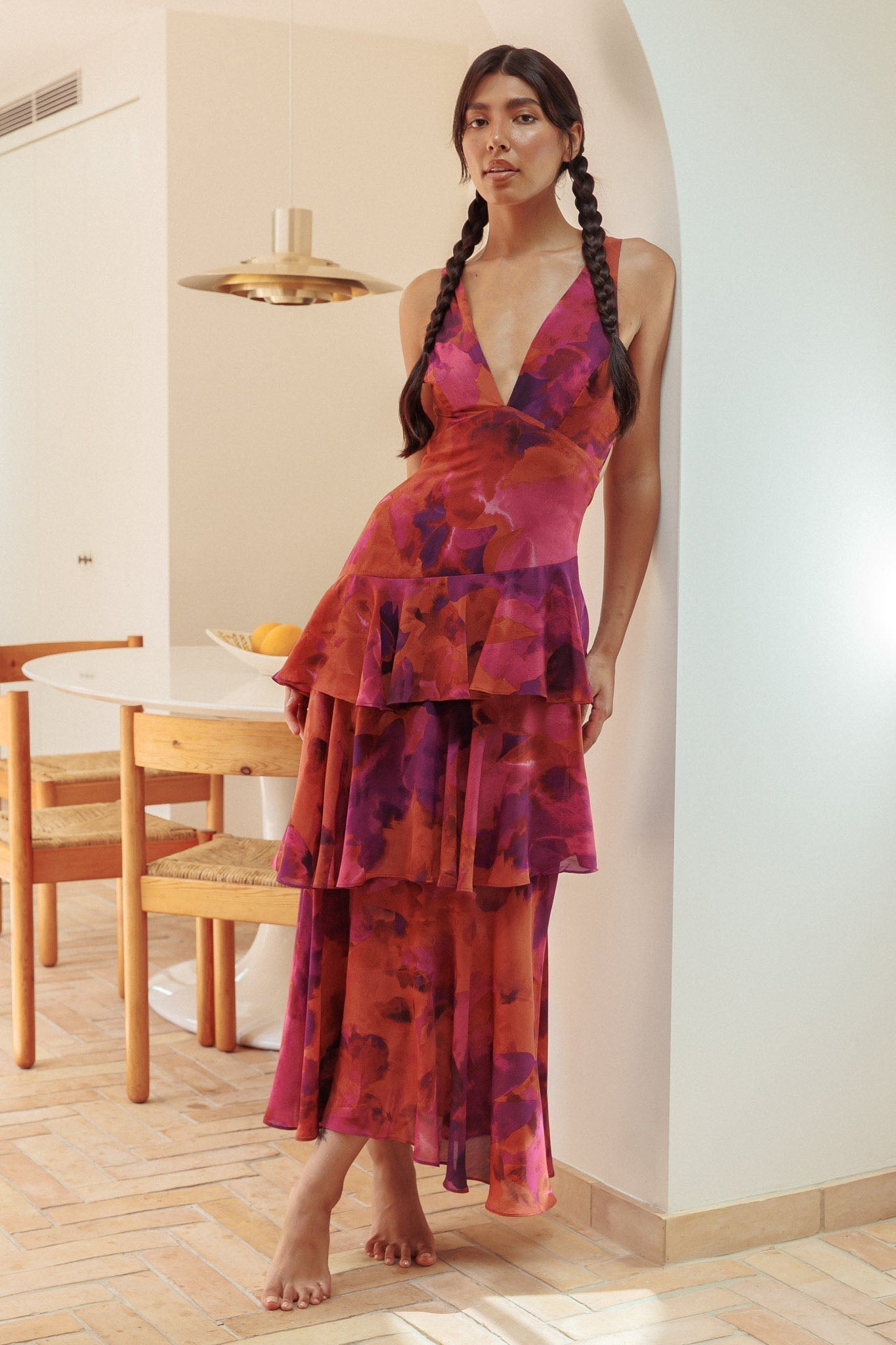 Harriet Ruffle Maxi Dress in rich magenta and orange floral, with a deep V-neck and elegant tiered design.