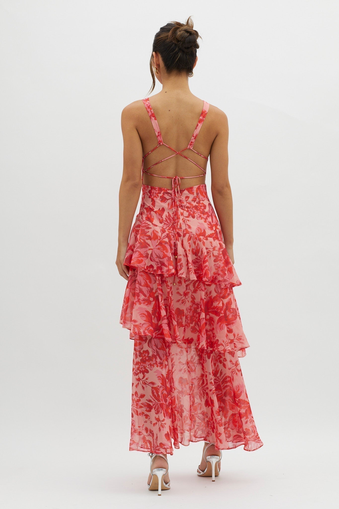 Back view of the pink and red floral Harriet Ruffle Maxi Dress, showing criss-cross straps and tiered ruffles.