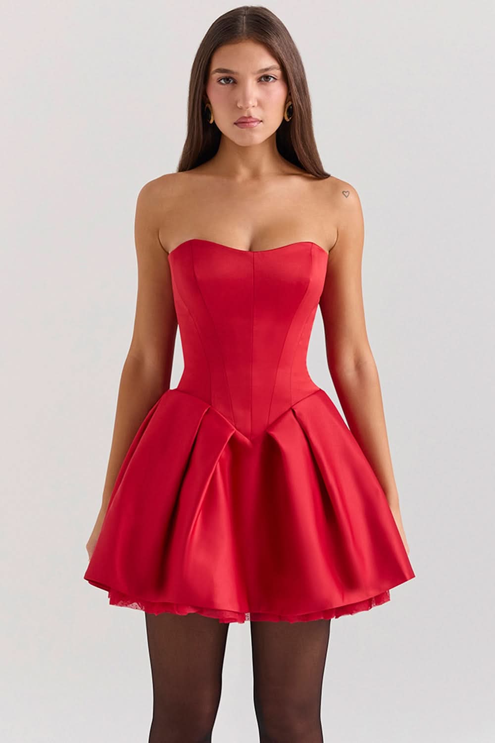 Close-up front view of a red strapless sweetheart mini dress on a model.