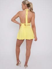 Rear view of a yellow halter mini dress with a full, flowing skirt and tie-back detail.