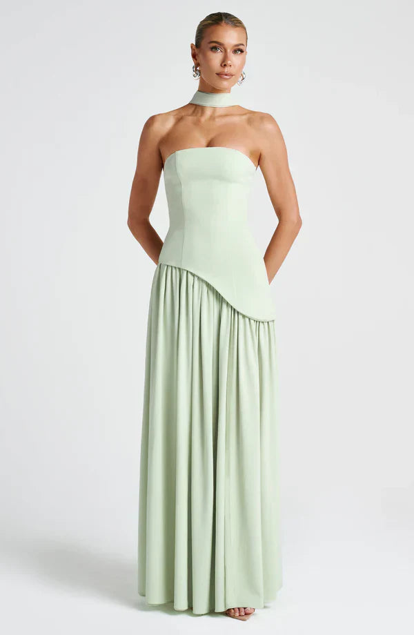 Light sage green strapless maxi dress featuring an asymmetrical peplum waist and a matching choker neckline.