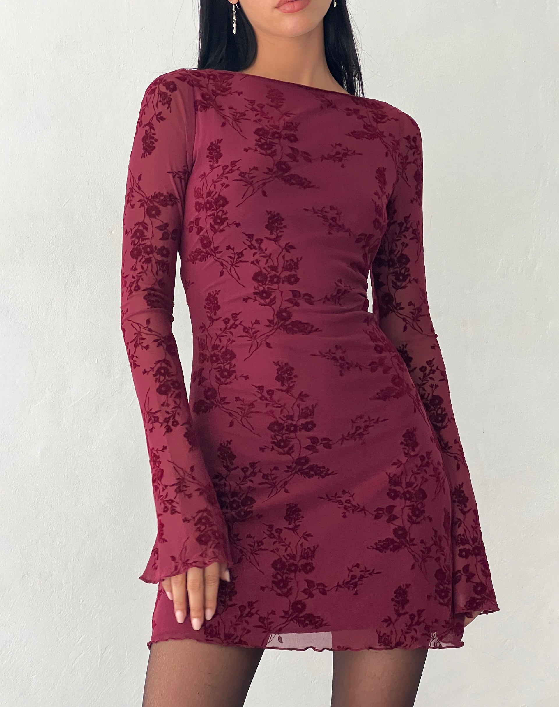 Close-up front view of the dark red Rosalie Scalloped Mini Dress, detailing the long sleeves and subtle floral pattern.