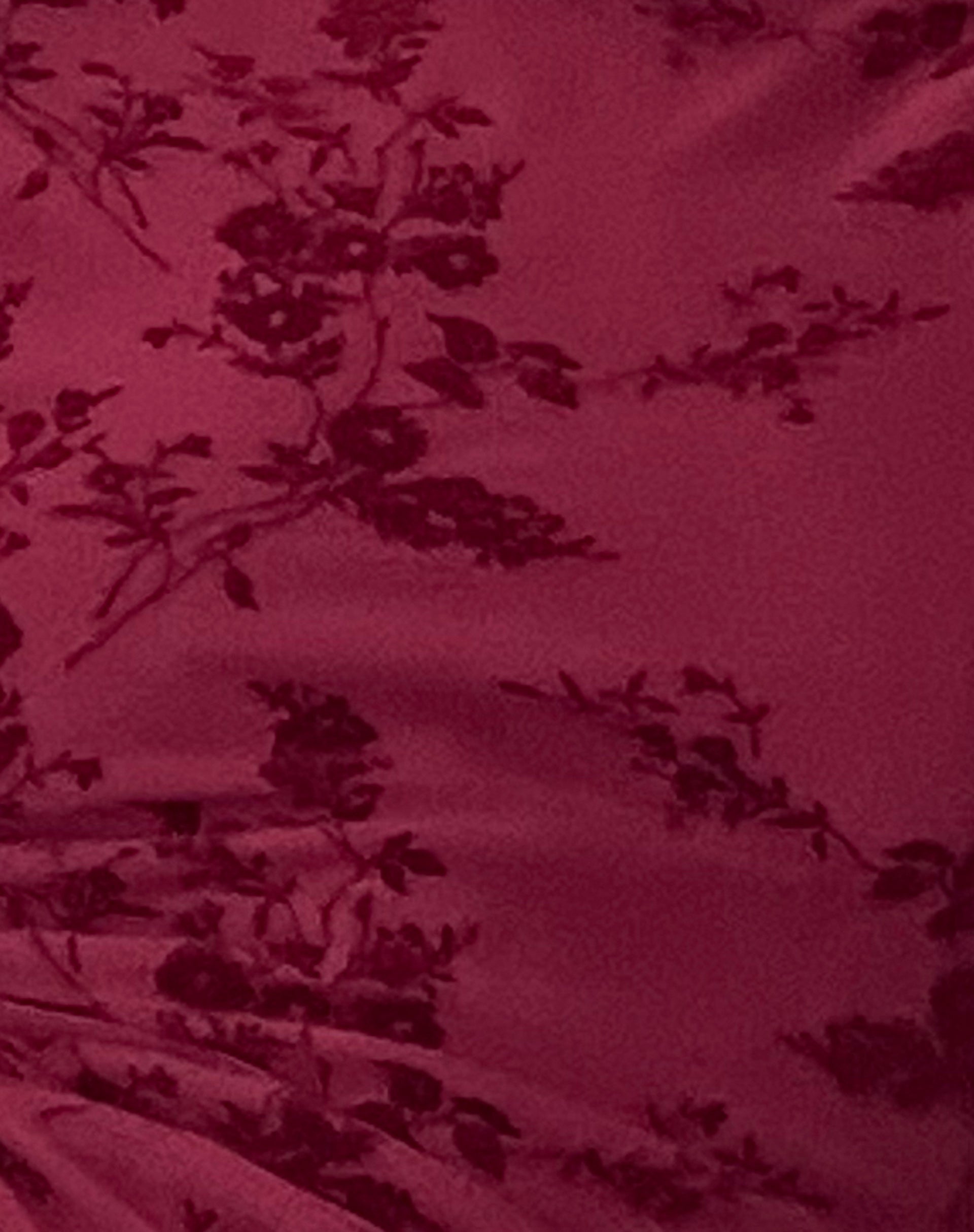 Detailed close-up of the dark red fabric of the Rosalie Scalloped Mini Dress, showing the velvet floral pattern texture.