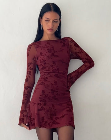 Front view of a dark red Rosalie Scalloped Mini Dress with long sleeves and subtle floral pattern, worn by a model.
