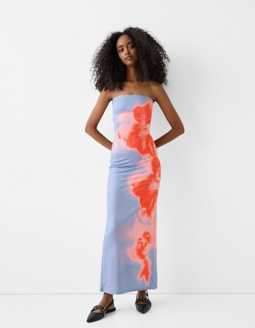 Blue strapless bodycon maxi dress with orange and coral blurred floral print for women, full frontal view.