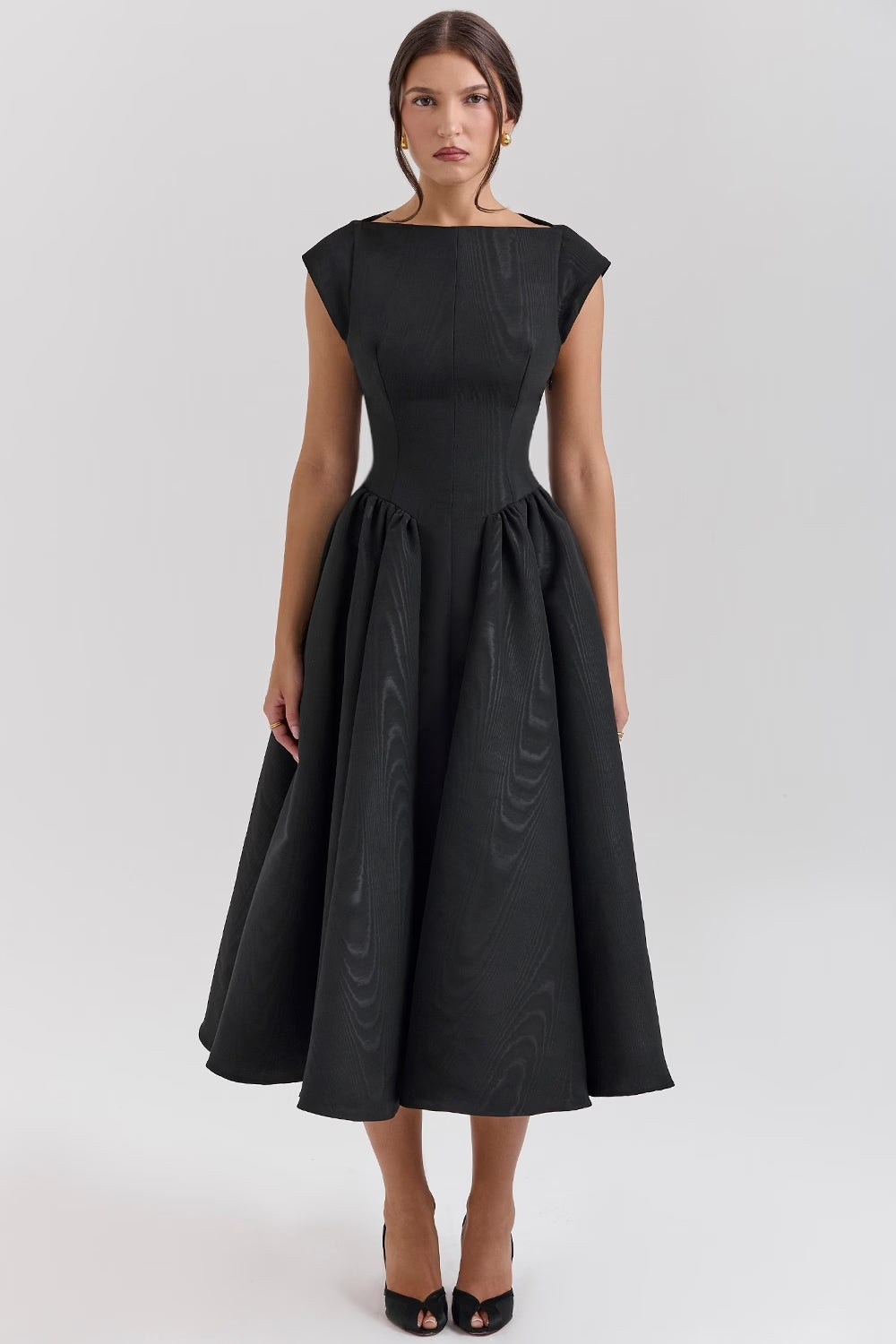 Black midi dress with open-back detail and sculpted waist — back view highlighting elegant design.