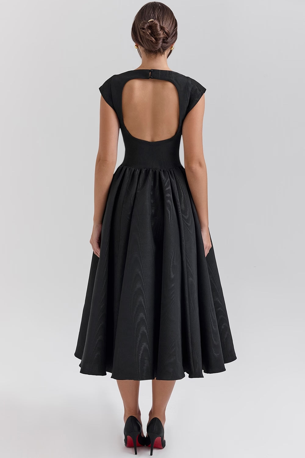 Back view of the black Sara midi dress, highlighting the elegant open-back design and full pleated skirt.