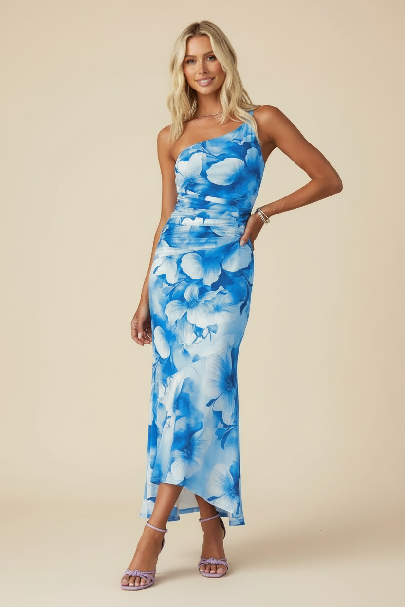 Light blue floral one-shoulder ruched maxi dress with a high-low hem, side pose with hand on hip.