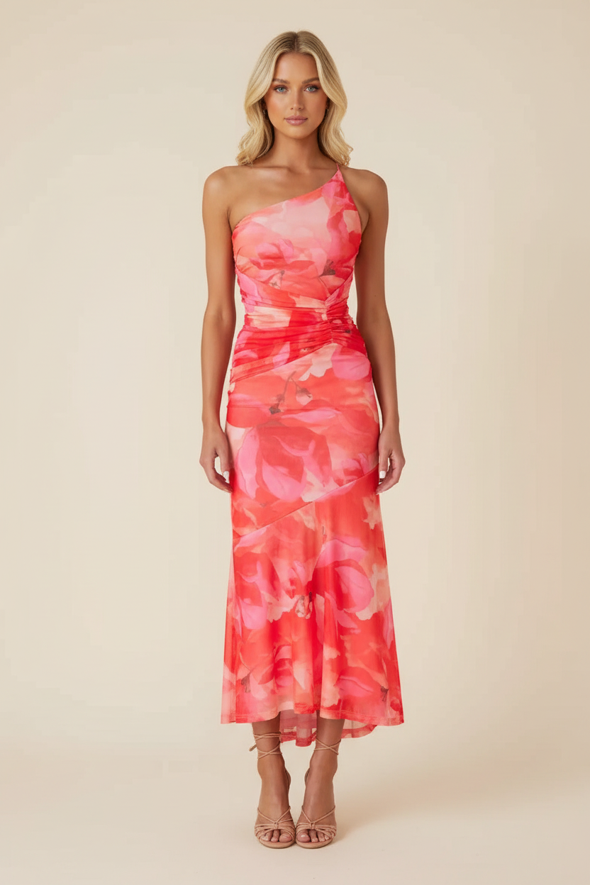 Red and pink floral one-shoulder ruched maxi dress with a high-low hem and nude heels, full front view.