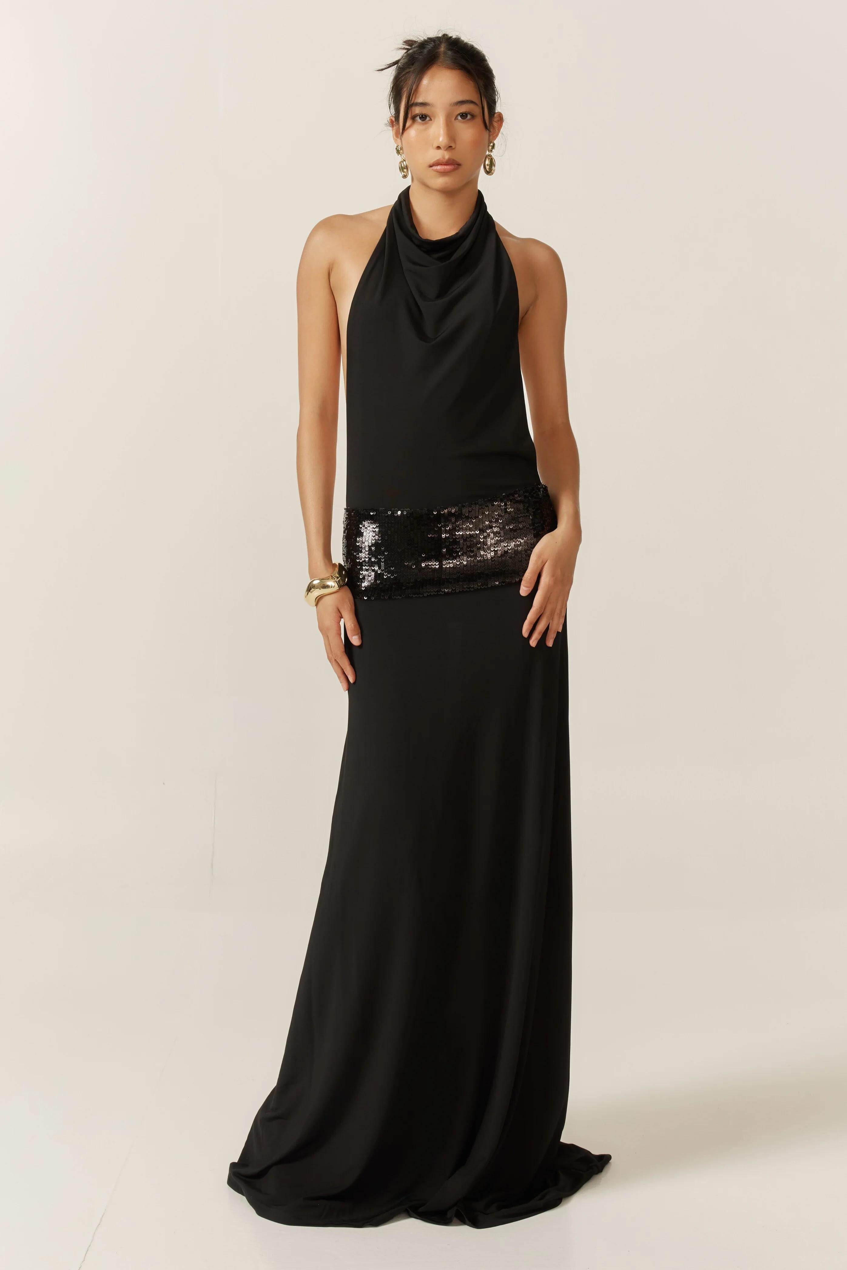 Front view of black halter neck Simone Sequin Maxi Dress with cowl neck and wide sequin band.
