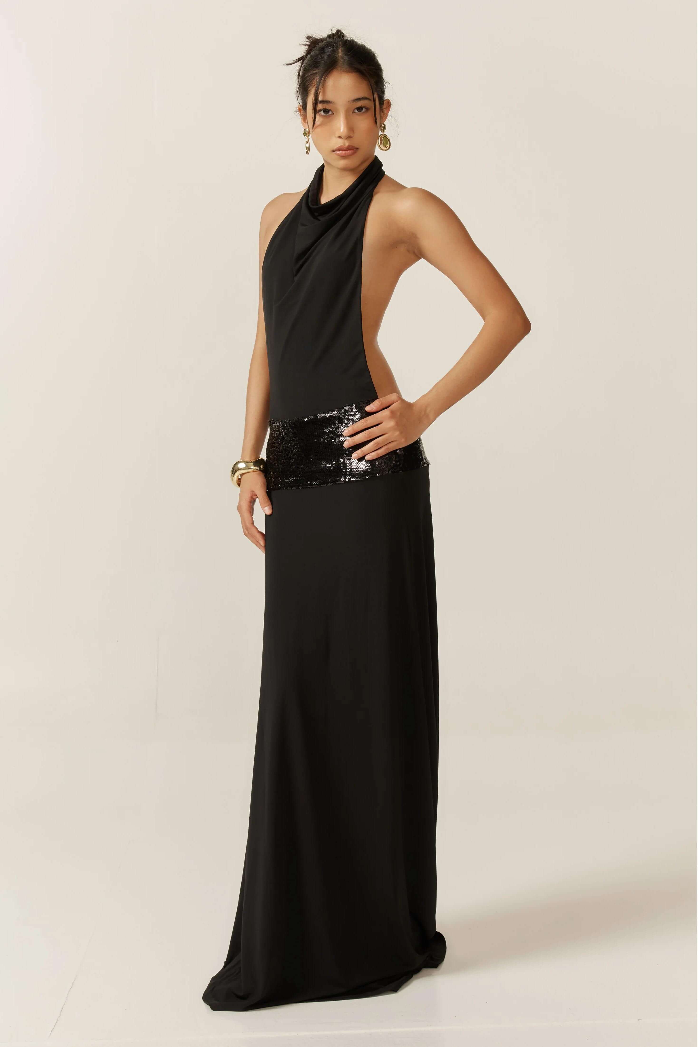 Black Simone Sequin Maxi Dress, front 3/4 view, with open back and sequin detail at the waist.