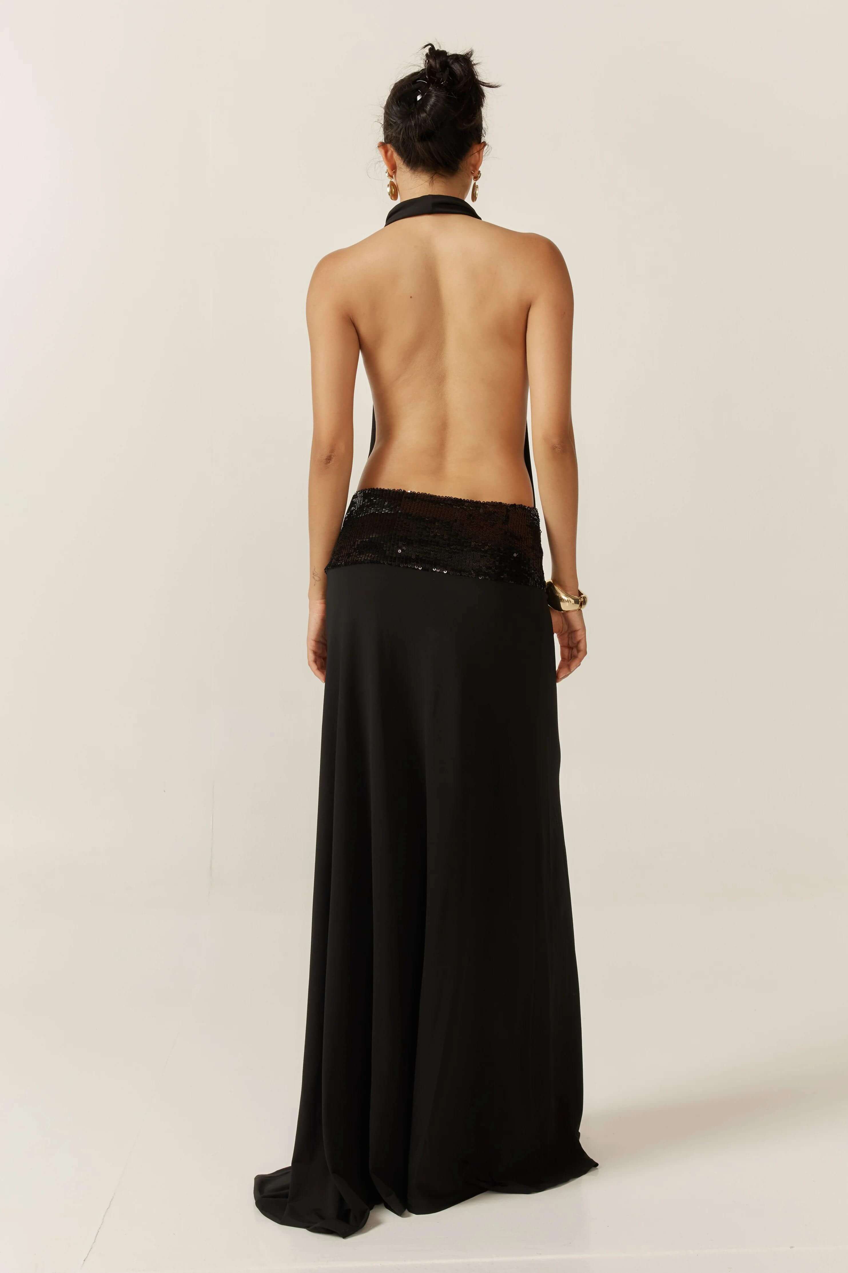 Back view of the black Simone Sequin Maxi Dress, showing the open back and sequin details.