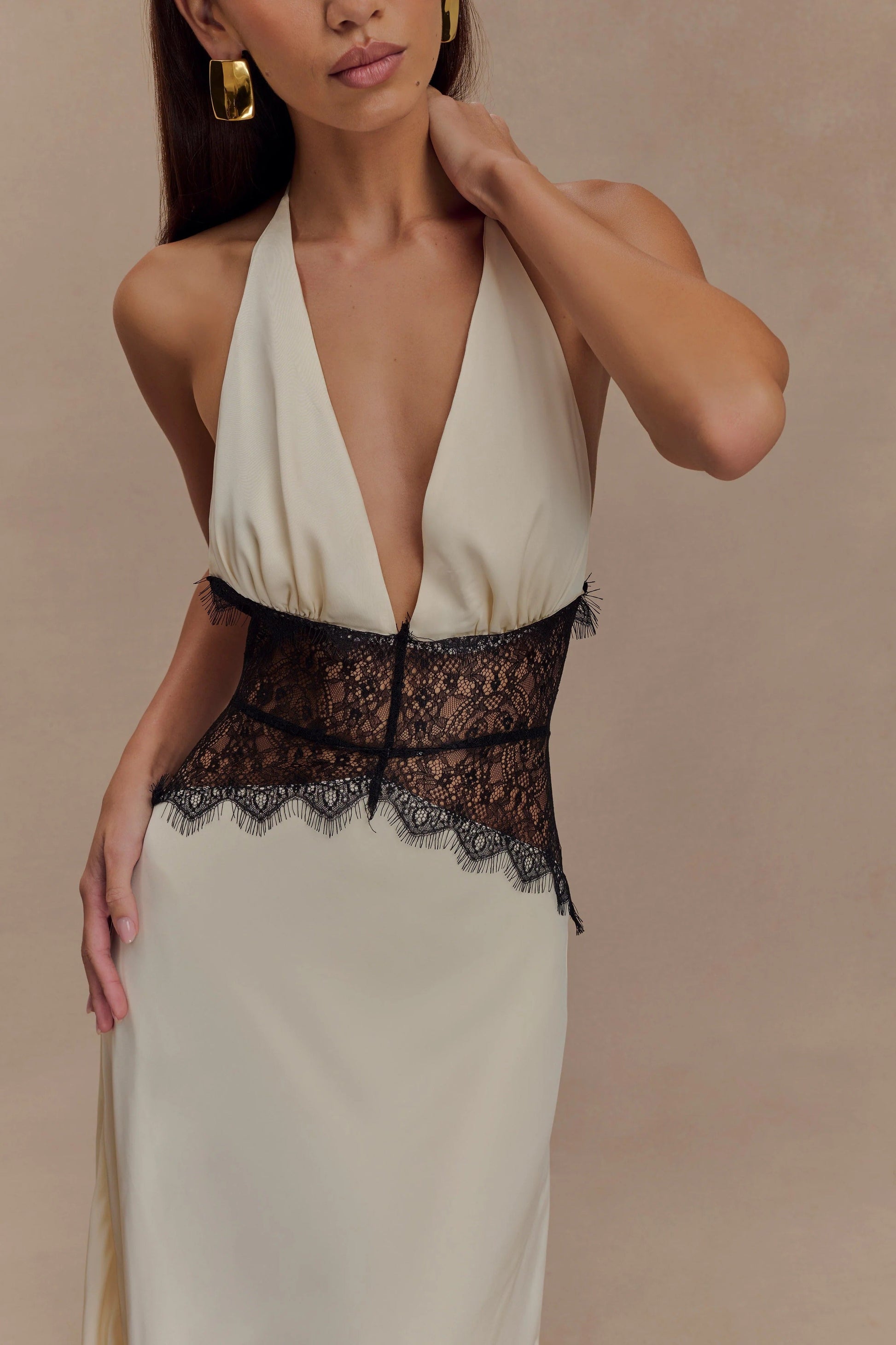 Close-up of the cream Skye Lace Maxi Dress bodice, highlighting the deep V-neck, ruched detail, and intricate black lace.