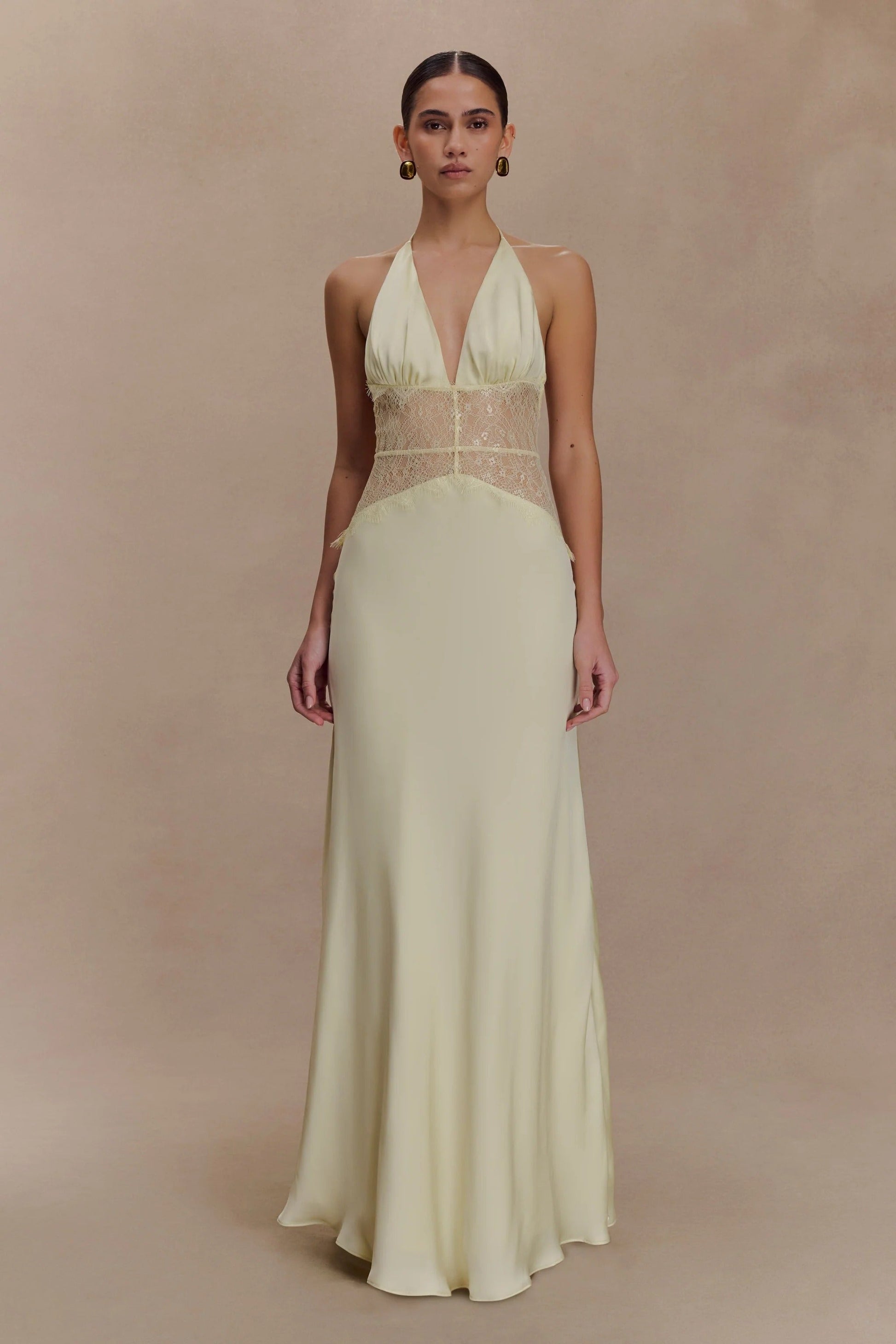 Pale yellow Skye Lace Maxi Dress with a halter neckline and delicate tonal lace inserts on the bodice.