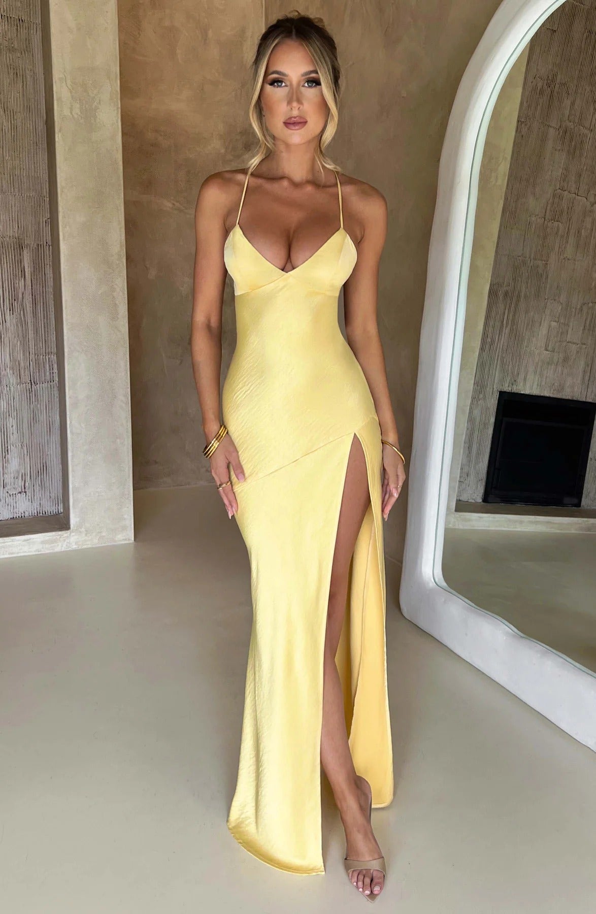 Vibrant yellow satin slit maxi dress with a flattering sweetheart bust and delicate spaghetti straps, a bright statement piece.