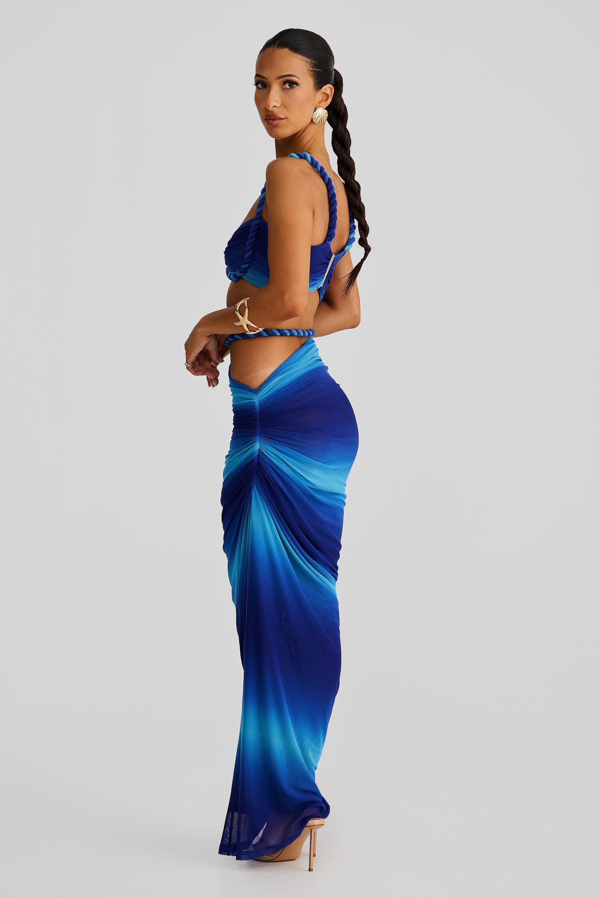 Side profile of a blue ombre Sophie Braided Maxi Set, showing the braided straps and waist detail, paired with a flowing maxi skirt.