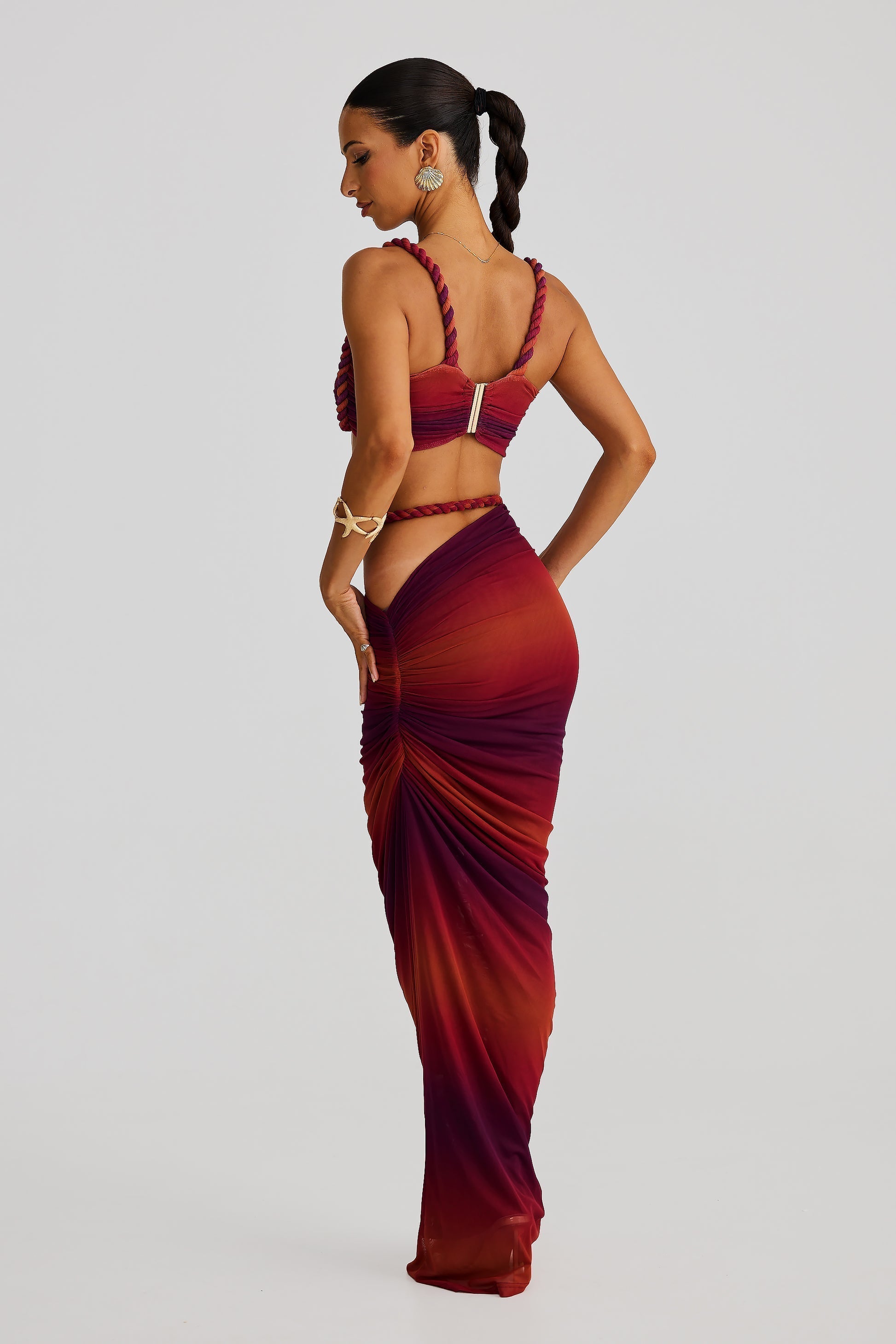 Back view of the red ombre Sophie Braided Maxi Set, highlighting the braided rope details on the top and the ruched maxi skirt.